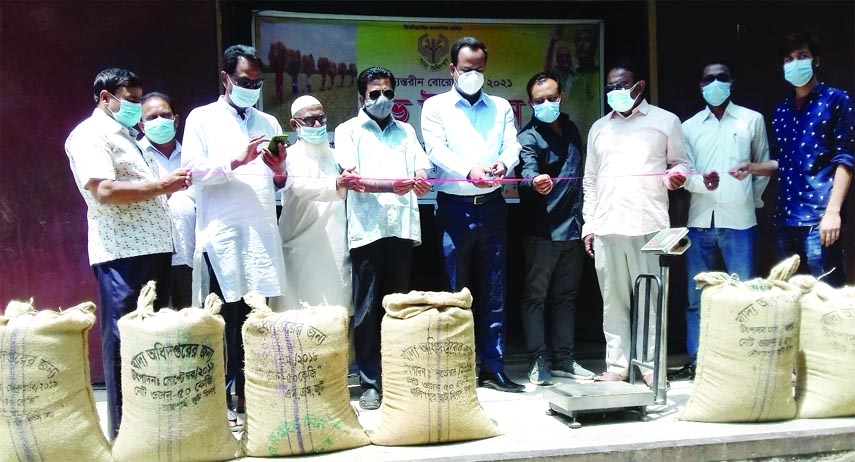 Bonpara Upazila Nirbahi Officer Md Zahangir Alam inaugurates wheat procurement programme by cutting a red lace on Saturday while Bonpara Pouro Mayor KM Jakir Hossain, LSD Godown Officer Tanmoy Biswas, Chairman of Mills-Owners Association Abu Hena Mostafa