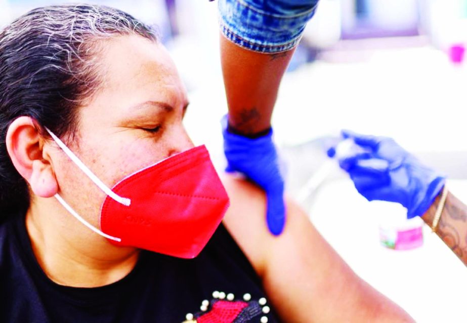 A woman receives her first dose of the Pfizer Covid-19 vaccine from a health care worker at a clinic targeting Central American Indigenous residents at CIELO, an Indigenous rights organisation in Los Angeles, California.