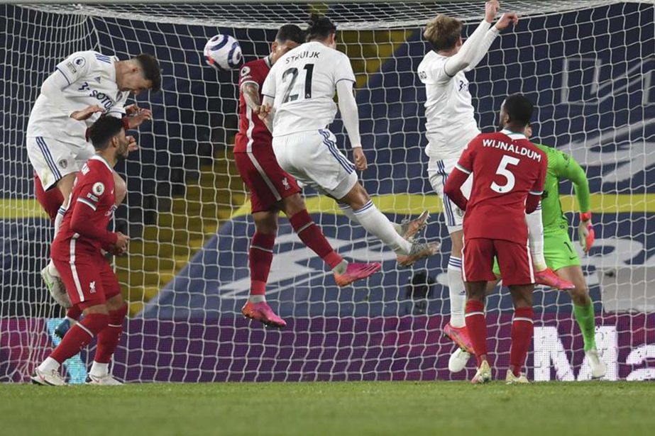 Leeds United's Diego Llorente (left) scores his side's opening goal during the English Premier League soccer match between Leeds United and Liverpool at the Elland Road stadium in Leeds, England on Monday.