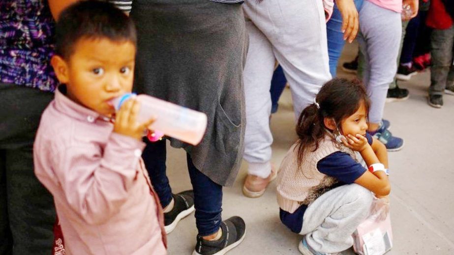 Migrant children wait to enter a temporary shelter in Ciudad Juárez, Mexico.