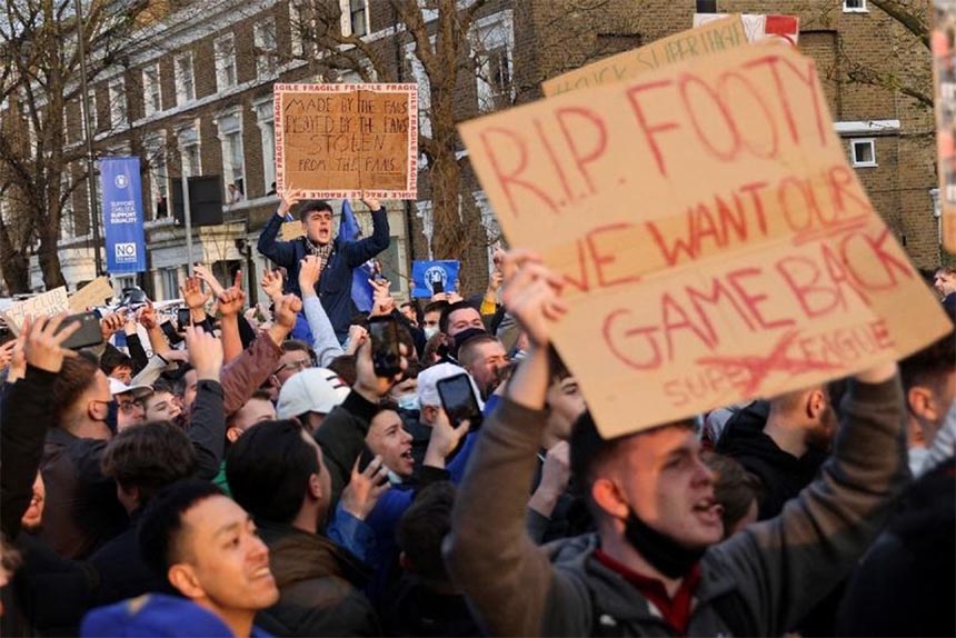 Football supporters demonstrate against the proposed European Super League outside of Stamford Bridge football stadium in London on Tuesday, ahead of the English Premier League match between Chelsea and Brighton & Hove Albion.