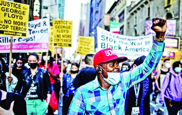 People march with signs after the verdict in the trial of former Minneapolis police officer Derek Chauvin, found guilty of the death of George Floyd, in New York City.