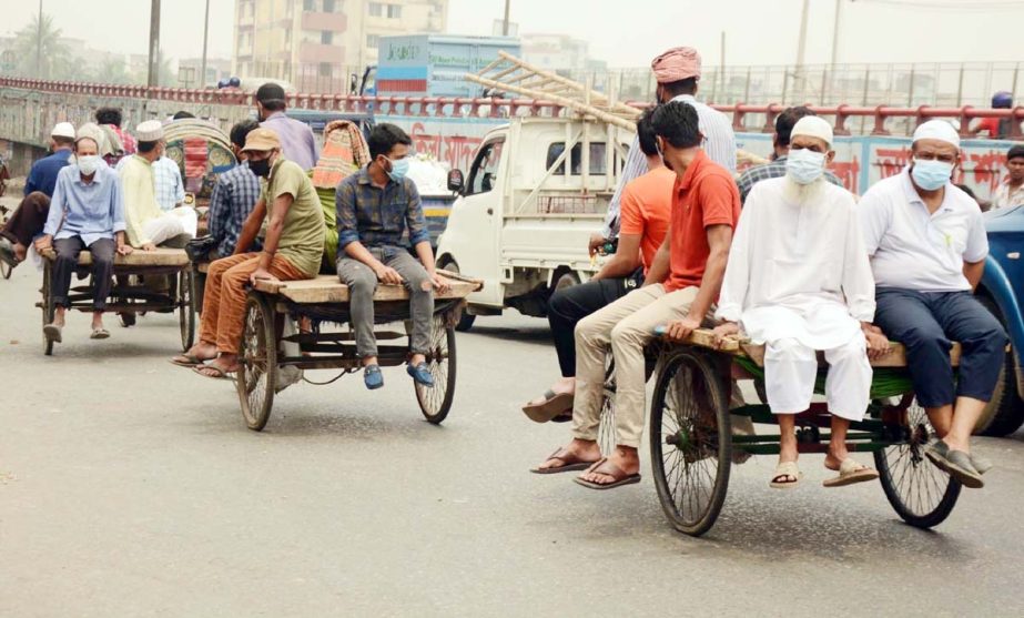 Due to absence of transport commuters going to their respective destination boarding on rickshaw-vans. The snap was taken from Jatrabari area on Thursday.