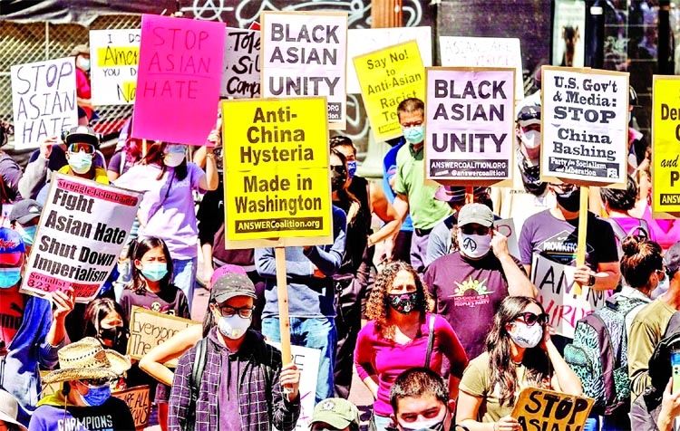 Demonstrators hold signs during a rally against anti-Asian hate crimes outside City Hall in Los Angeles, California, US.