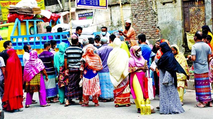 The people of low-income crowd the TCB truck to buy essential commodities. The snap was taken from Mirpur area in the city on Friday.