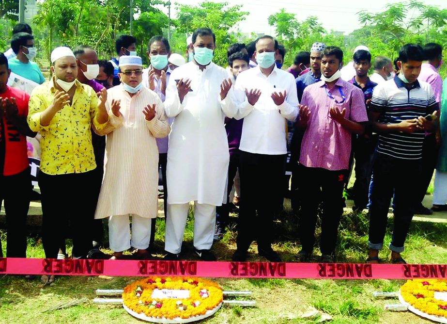 People of different organisations offer munajat at Jurain Graveyard in the city on Saturday for the salvation of the departed souls of those who were killed in Rana plaza collapse marking its 8th anniversary.