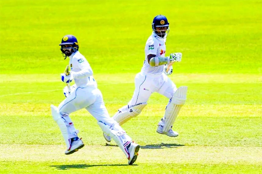 Dimuth Karunaratne and Dhananjaya de Silva of Sri Lanka running between wickets during the fourth day of the first Test between Bangladesh and Sri Lanka at Pallekele International Cricket Stadium in Kandy, Sri Lanka on Saturday.