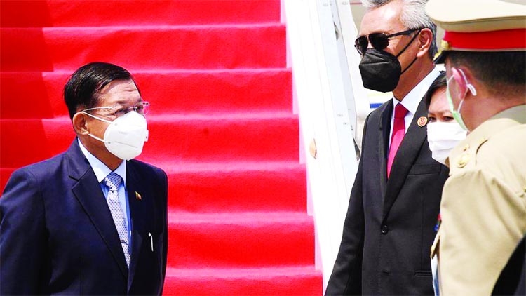 Myanmar's military government chief Min Aung Hlaing, left, is seen upon his arrival at the Soekarno Hatta International airport in Tangerang, on the outskirts of Jakarta.