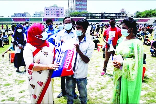 DC Chandpur Anjana Khan Majlish at a food aid programme distributes relief among 500 destitute, workless and unemployed poor including beggars, hair dressers, restaurant staffs transport workers who lost work due to lockdown at Chandpur District Stadium o