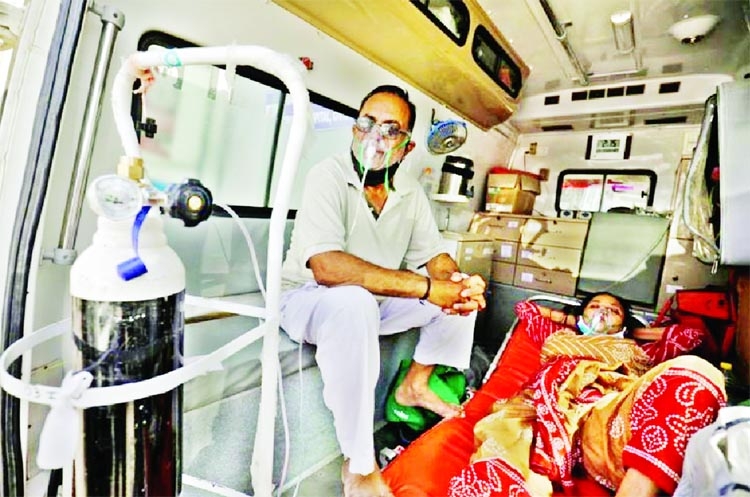 Patients with a breathing problem wait inside an ambulance to enter a Covid-19 hospital for treatment, amidst the spread of the coronavirus in Ahmedabad, India.