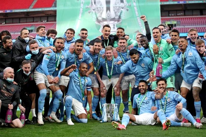 Manchester City players celebrate with the trophy after winning the English League Cup final football match between Manchester City and Tottenham Hotspur at Wembley Stadium, northwest London on Sunday.