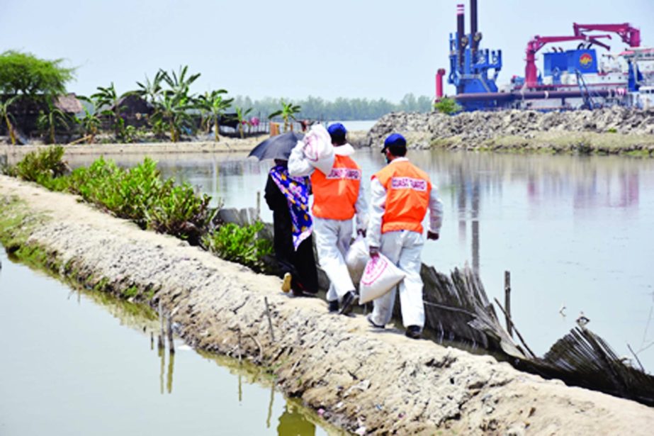 Bangladesh Coast Guard and Bidyananda Foundation jointly distribute relief goods among the 150 destitute families of Mongla on Sunday.