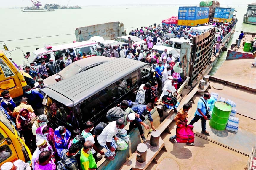 A huge number of people are seen coming back to Dhaka from different districts across Bangladesh by boarding a ferry on Tuesday after the government allowed the reopening of the shops and shopping malls during the ongoing countrywide lockdown.