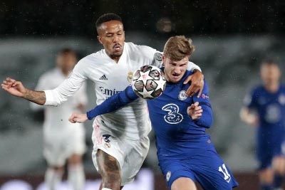 Chelsea's Timo Werner (front) vies for the ball with Real Madrid's Eder Militao (left) during the Champions League semi-final first leg soccer match between Real Madrid and Chelsea at the Alfredo di Stefano stadium in Madrid, Spain on Tuesday.