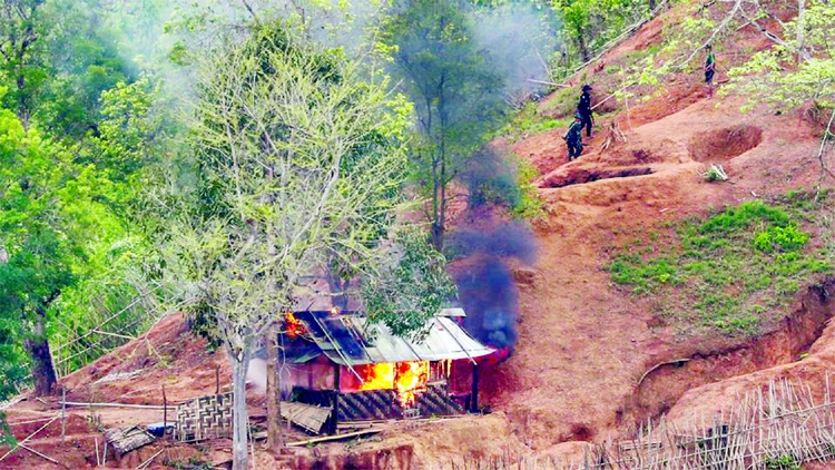 Ethnic minority Karen troops are seen after setting fire to a building inside a Myanmar army outpost near the Thai border, which is seen from the Thai side on the Thanlwin, also known as Salween, riverbank in Mae Hong Son province, Thailand on Wednesday.