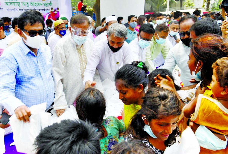 Information and Broadcasting Minister Dr. Hasan Mahmud distributes Eid gifts among the distressed children on the Central Shaheed Minar premises in the city on Thursday.