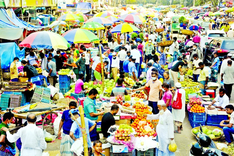 Hundreds of people throng Karwan Bazar area in the city to buy iftar items on Thursday showing less regard to health safety rules despite lockdown to prevent spread of corona.