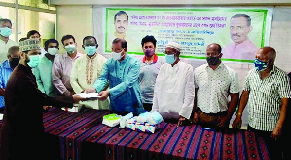 Former city mayor and general secretary of city Awami League AJM Nasiruddin distributes donation cheques to imams, muazins of 15 mosques in the port city on Wednesday.