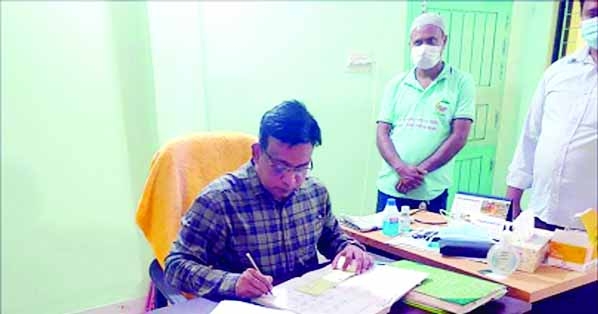 The newly elected Mayor of Shibganj Municipality, Syed Monirul Islam recently signs cheques to pay the salary and Eid bonus to the officers and employees of the municipality.