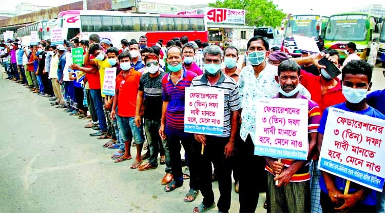 Road transport workers staging a demonstration at the Mohakhali inter-district bus terminal on Sunday to press their demands.