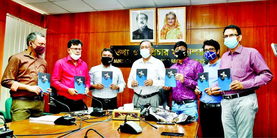 Information and Broadcasting Minister Dr. Hasan Mahmud, among others, holds the copies of a book titled 'Mon Kharaper Poster' at its cover unwrapping ceremony in the seminar room of the ministry on Monday. PID photo