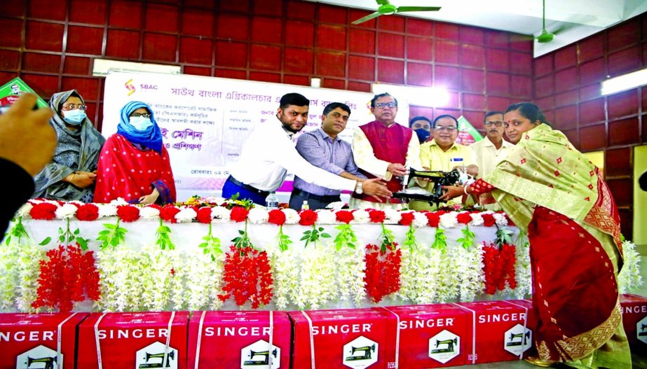 SBAC Bank Chairman SM Amzad Hossain along with ANM Faizul Haque, Deputy Commissioner of Bagerhat distributing sewing machines among 100 women under the bank's CSR fund at Fakirhat Upazila Prishad in Bagerhat on Sunday. Senior officials of the bank and lo
