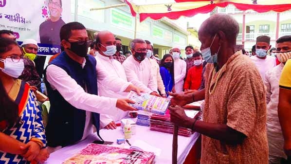 Deputy Minister of Water Resources, AKM Enamul Haque Shamim, MP distributes Eid gifts among 1000 poor families of Naria upazila under Shariatpur district on Sunday.