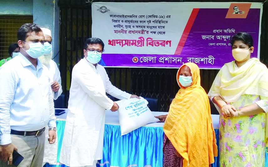 Rajshahi Deputy Commissioner Abdul Jalil distributes food assistance among the poor and distressed families of the district on Saturday.