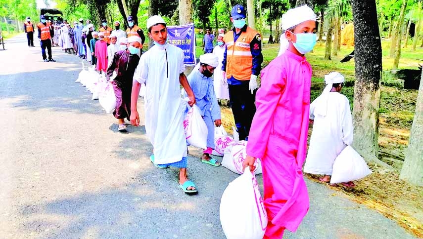 Patuakhali Coast Guard in collaboration with Vidyananda Zakat Foundation distributes relief goods among 200 helpless destitute children at Baufal of Patuakhali on Saturday.
