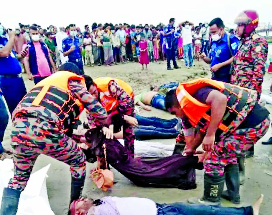 The bodies of victims being recovered following a collision between a sand-laden bulk carrier and a passenger speedboat on the Padma River in Madaripur's Shibchar on Monday.