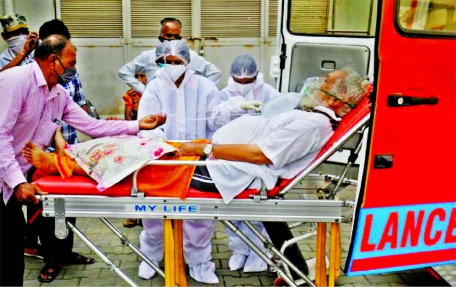 A patient wearing an oxygen mask is wheeled inside a Covid-19 hospital for treatment, amidst the spread of the coronavirus in Ahmedabad, India.