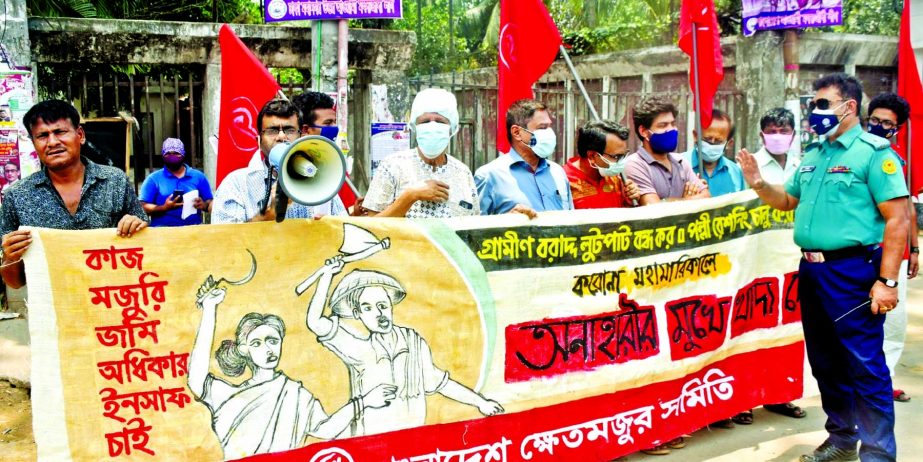 'Bangladesh Khetmajur Samity' forms a human chain in front of the Jatiya Press Club on Wednesday with a call to introduce village rationing system.