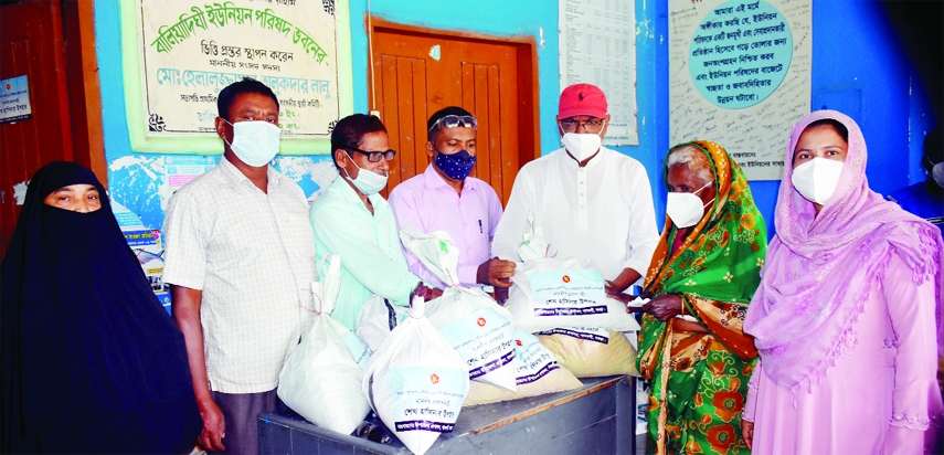 Mahbubur Rahman Mahbub, Chairman of Baliadighi Union Parishad of Bogura Gabtoli distributes PM's grants and masks among 250 poor, distressed families of the locality on Tuesday.