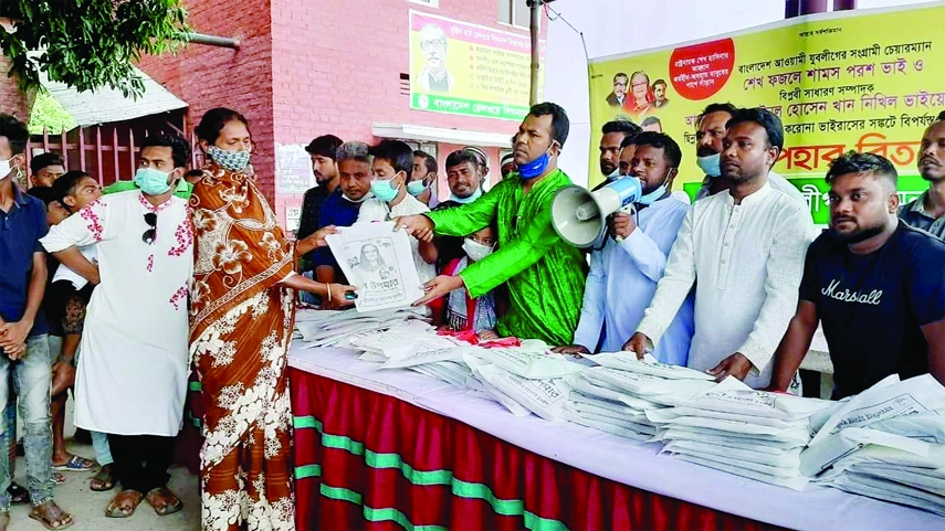 Leaders and activists of Bangladesh Jubo League, Mymensingh Mohanagar unit distribute The Prime Minster's gift of Eid clothes among 100 male, female and children at Mymensingh Railway Station on Wednesday.