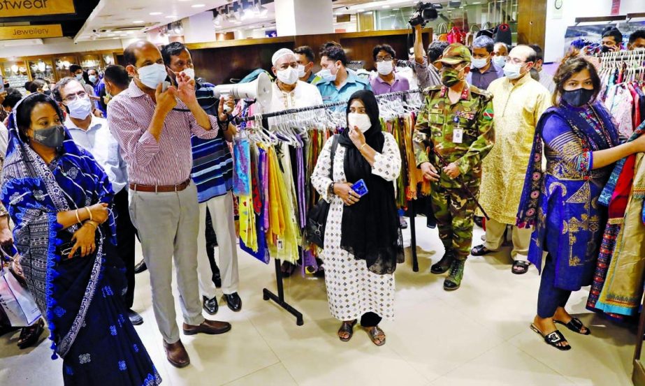 DNCC Mayor Atiqul Islam inspects different shopping malls in the city's Mohammadpur area on Thursday to see whether health guidelines being followed.