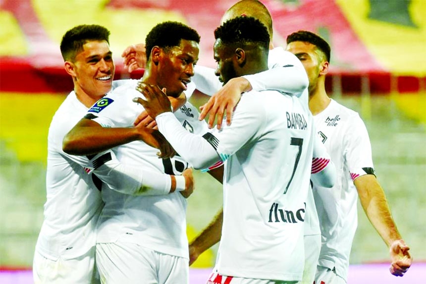 Lille's forward Jonathan David (2nd left) celebrates with teammates after scoring a goal during the French L1 football match against Lens at the Bollaert Stadium, in Lens, northern France on Friday.