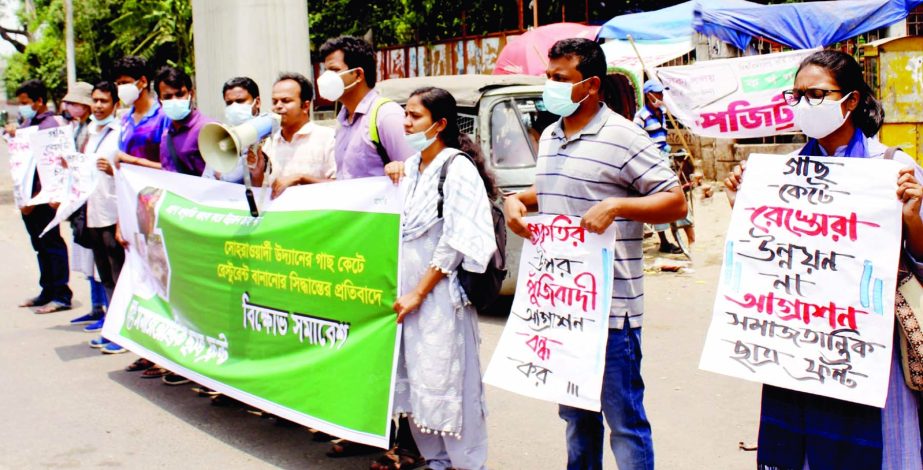 Samajtantrik Chhatra Front forms a human chain at Shahbagh on Saturday in protest against decision to make restaurant cutting trees in the city's Suhrawardy Udyan.