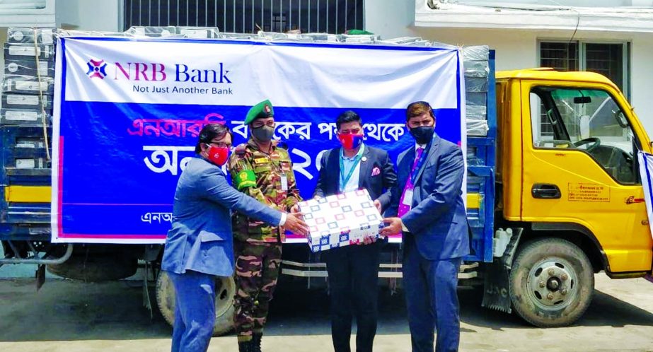 Senior officials of NRB Bank Limited handing over essential food packets to the authority of President's Relief Fund at Bangabhaban recently as part of CSR of the bank.