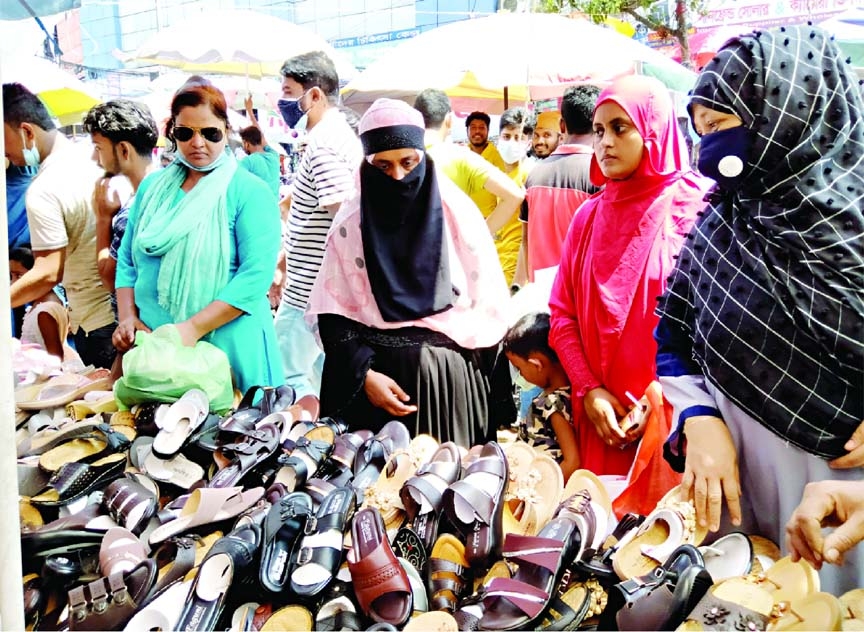 Eid shoppers throng at a market for shoes in the capital’s Ramna Bhaban on Saturday.