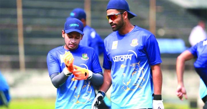 Mushfiqur Rahim (left) and Tamim Iqbal chatting during the practice session of Bangladesh preliminary cricket squad at the Sher-e-Bangla National Cricket Stadium (SBNCS) in the city's Mirpur on Monday.