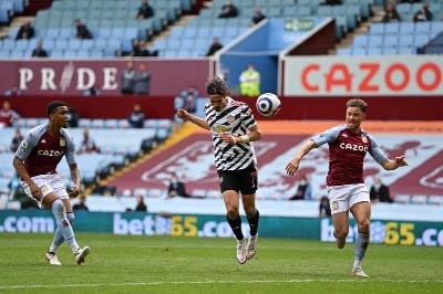 Manchester United's striker Edinson Cavani (center) heads the ball to score his team's third goal in the English Premier League football match against Aston Villa at Villa Park in Birmingham, central England on Sunday.