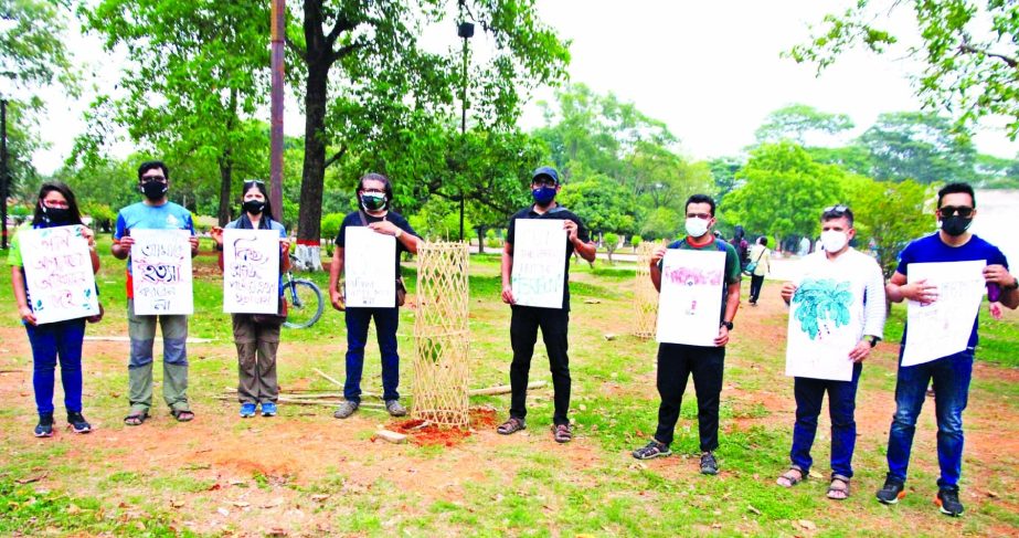 General citizens form a human chain in the city's Suhrawardy Udyan on Monday in protest against cutting of trees of the udyan.