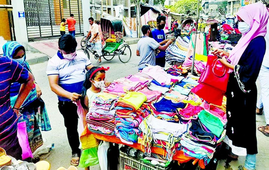 Sparse presence of buyers at a makeshift cloths shop due to corona pandemic. The snap was taken from the city's Jhigatala area on Monday.