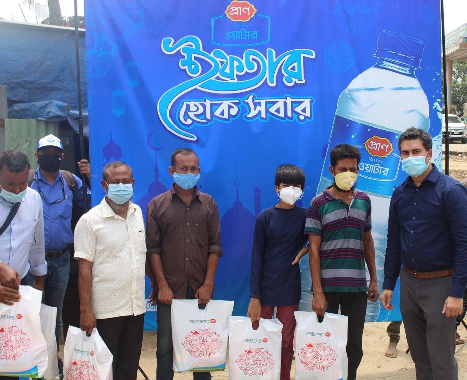 Senior officials of PRAN Drinking Water, a concern of PRAN-RFL Group, poses for photo after handed over food items to helpless and poor people in the capital recently. Al Amin Shikder, Senior Brand Manager and Tonmoy Das, Head of Marketing of the brand we