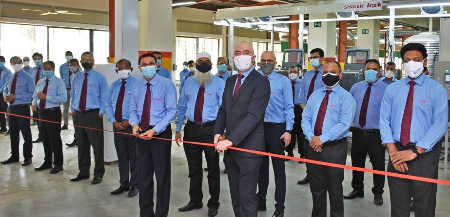 MHM Fairoz, Managing Director and CEO of SINGER Bangladesh Limited, inaugurating the production of manufacturing Washing Machines at the plant of the company in Savar recently. Senior officials of the company were present.