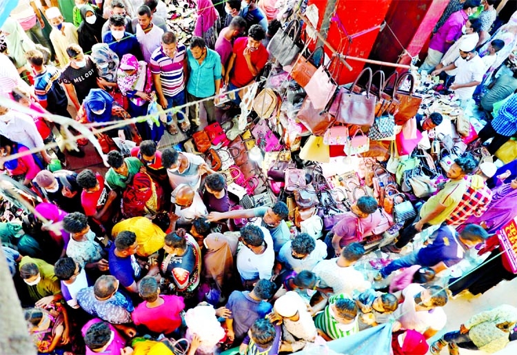 Customers throng Gausia market in the capital on Monday for last minute shopping ahead of Eid flouting social distancing norms.