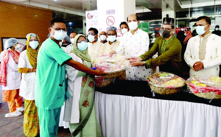 Mayor of Dhaka North City Corporation Md. Atiqul Islam distributes Eid gifts among DNCC Covid Dedicated Hospital nurses and servicemen in the capital on Friday.