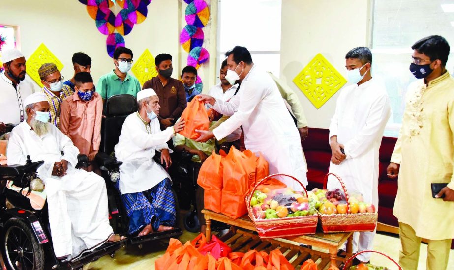 Officials of PMO distribute gifts among war-wounded freedom fighters on behalf of Prime Minister Sheikh Hasina marking the Holy Eid-ul-Fitr prayer at Muktijoddha Tower in city's Mohammadpur area on Friday.