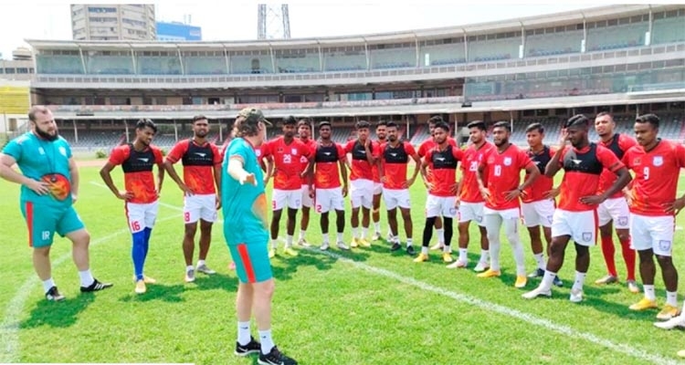 Preliminary squad of Bangladesh footballers with Head Coach Jamie Day during their practice session at the Bangabandhu National Stadium on Monday.