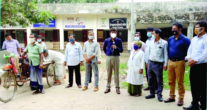 Kaharol Upazila Health and Family Planning Officer Dr. Mohammad Shafiul Azam speaks at a mass awareness campaign against spreading of corona virus at Kaharol on Monday.